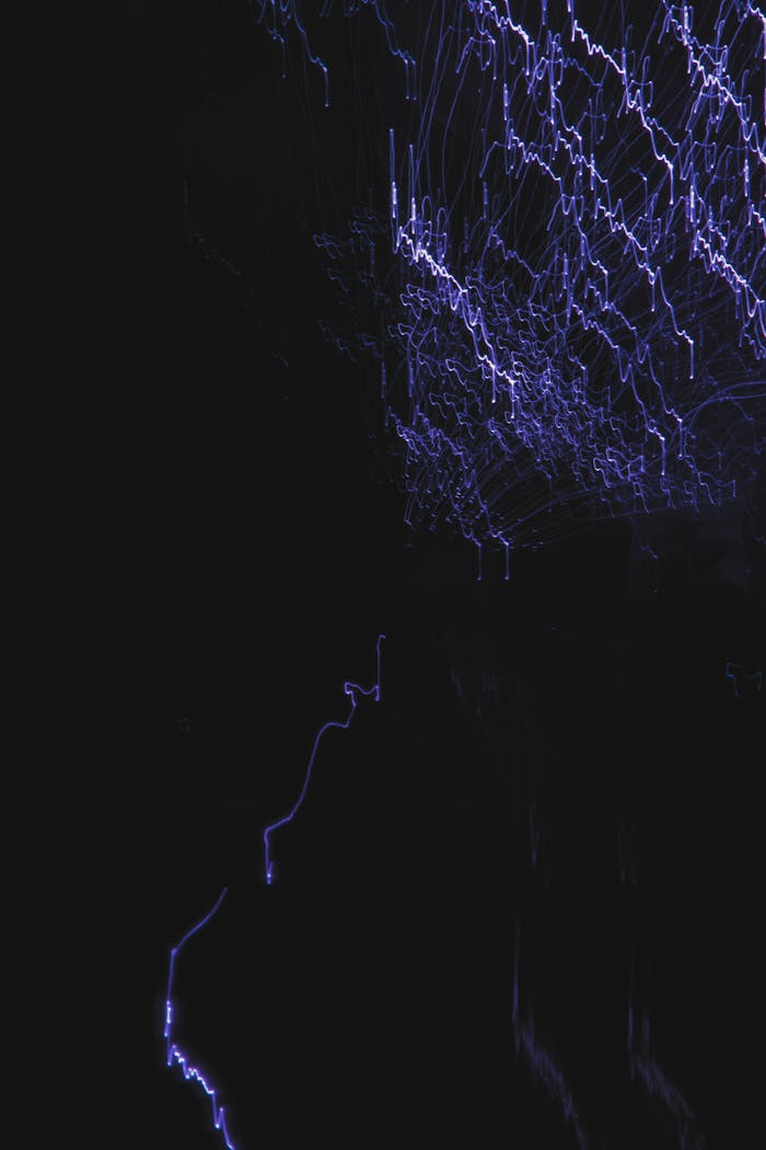why-choose-us Creative abstract image featuring electric blue light streaks against a dark background.